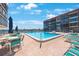 Inviting community pool with lounge chairs and umbrellas, perfect for relaxation and recreation at 19701 Gulf Blvd # 231, Indian Shores, FL 33785