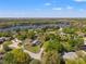 Scenic aerial view of a neighborhood near a lake, showcasing lush greenery and well-spaced homes at 20315 Mid Ct, Lutz, FL 33558