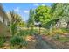 Beautiful backyard with lush greenery, a charming gate, and manicured landscaping at 20315 Mid Ct, Lutz, FL 33558