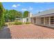 Spacious brick patio with french doors and mature landscaping at 20315 Mid Ct, Lutz, FL 33558