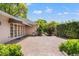 Spacious brick patio with french doors and mature landscaping at 20315 Mid Ct, Lutz, FL 33558