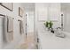 Bright bathroom featuring double sink, decorative shutters, and marble floors at 20315 Mid Ct, Lutz, FL 33558