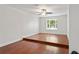 Spacious bedroom with hardwood floors, neutral walls, and a window with a view at 20315 Mid Ct, Lutz, FL 33558