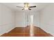Neutral bedroom with hardwood floors, ceiling fan, and access to walk-in closets at 20315 Mid Ct, Lutz, FL 33558