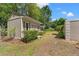 Cozy home exterior featuring neutral siding, decorative shutters, and well-maintained landscaping at 20315 Mid Ct, Lutz, FL 33558