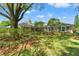 Charming single-story home featuring lush landscaping, mature trees, and a well-manicured lawn at 20315 Mid Ct, Lutz, FL 33558