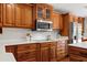 Stylish kitchen with wood cabinets, quartz countertops, and stainless steel appliances at 20315 Mid Ct, Lutz, FL 33558