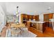 Open kitchen with custom wood cabinets, large island, stainless appliances, and eat-in dining at 20315 Mid Ct, Lutz, FL 33558