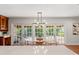 Bright breakfast nook features a modern light fixture, patio access, and adjoins the kitchen at 20315 Mid Ct, Lutz, FL 33558