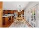 Open-concept kitchen and breakfast nook featuring custom cabinets, stainless steel appliances, and access to the patio at 20315 Mid Ct, Lutz, FL 33558
