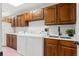 Spacious laundry room with white washer and dryer, lots of storage, and countertop space at 20315 Mid Ct, Lutz, FL 33558