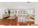 Bright living room featuring hardwood floors, a neutral color scheme, and sliding glass doors to the backyard at 20315 Mid Ct, Lutz, FL 33558
