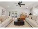 Spacious living room featuring hardwood floors, neutral decor, and french doors at 20315 Mid Ct, Lutz, FL 33558