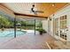 Covered patio area with brick flooring overlooking the pool and well-maintained landscaping at 20315 Mid Ct, Lutz, FL 33558