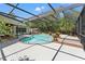 Sparkling pool with a screened enclosure, brick steps, and patio for outdoor enjoyment at 20315 Mid Ct, Lutz, FL 33558