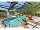Sparkling pool with a screened enclosure, brick steps, and patio for outdoor enjoyment at 20315 Mid Ct, Lutz, FL 33558