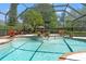 Screened-in pool with stone garden beds and a view of the backyard at 20315 Mid Ct, Lutz, FL 33558