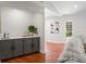 Stylish wet bar with gray cabinets, subway tile backsplash, and hardwood floors at 20315 Mid Ct, Lutz, FL 33558