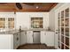 Outdoor wet bar featuring white cabinetry, granite countertop, mini fridge, tile backsplash, and brick floor at 20315 Mid Ct, Lutz, FL 33558
