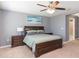 Spacious bedroom features a large window, neutral carpet, and a ceiling fan at 2126 Golden Falcon Dr, Ruskin, FL 33570