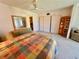 Bright bedroom featuring neutral carpet and large closet with mirrored sliding doors at 2370 Jamaican St # 46, Clearwater, FL 33763