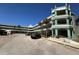A view of the exterior with palm trees and parking available in front of the condo building on a sunny day at 2370 Jamaican St # 46, Clearwater, FL 33763