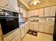 A cozy kitchen featuring vintage cabinetry and appliances in a bright, airy setting at 2370 Jamaican St # 46, Clearwater, FL 33763