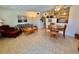 An open-concept living room with a tiled floor, comfortable seating, and adjacent dining area at 2370 Jamaican St # 46, Clearwater, FL 33763