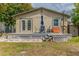 Back deck features a dining set with umbrella, offering a perfect spot for outdoor relaxation and entertaining at 2460 16Th N Ave, St Petersburg, FL 33713