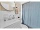 Clean bathroom featuring a modern sink, toilet, and blue shower curtain at 2460 16Th N Ave, St Petersburg, FL 33713