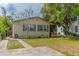 Charming home with a well-maintained front yard, mature trees, and a walkway leading to the entrance at 2460 16Th N Ave, St Petersburg, FL 33713