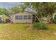 Quaint home boasts mature trees, a tidy lawn, and a welcoming entrance for a cozy curb appeal at 2460 16Th N Ave, St Petersburg, FL 33713