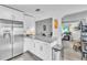 Modern kitchen with stainless steel appliances, granite countertops, and an opening to the living room at 2460 16Th N Ave, St Petersburg, FL 33713