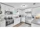 Modern kitchen with stainless steel appliances, granite countertops, and white cabinetry at 2460 16Th N Ave, St Petersburg, FL 33713