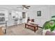 Bright living room featuring a ceiling fan, hardwood floors, and an opening to the kitchen at 2460 16Th N Ave, St Petersburg, FL 33713