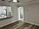 Open living area featuring wood-look floors and a breakfast bar connecting to the modern kitchen at 2460 16Th N Ave, St Petersburg, FL 33713