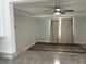 Well-lit living space with ceiling fan, wood-look flooring, and connection to kitchen area at 2460 16Th N Ave, St Petersburg, FL 33713