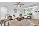 Spacious living room with hardwood floors, a comfortable sectional sofa, and bright natural light at 2460 16Th N Ave, St Petersburg, FL 33713