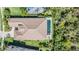 Aerial view of a home with a large private backyard featuring a long in-ground swimming pool, patio, and green grass at 2468 Coco Palm Cir, Wesley Chapel, FL 33543