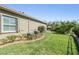 Green backyard shows lush landscaping, privacy hedges and trees, and outdoor lounge area at 2468 Coco Palm Cir, Wesley Chapel, FL 33543