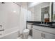 Clean bathroom offers a shower-tub combination with white tiles, and a white vanity with granite countertop at 2468 Coco Palm Cir, Wesley Chapel, FL 33543