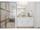 Updated bathroom featuring granite countertops, and a glass enclosed shower with bench seat at 2468 Coco Palm Cir, Wesley Chapel, FL 33543