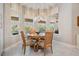Cozy breakfast nook with round table and large windows offering backyard views at 2468 Coco Palm Cir, Wesley Chapel, FL 33543