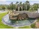 Stunning community entrance with stone accents, water features, and lush landscaping at 2468 Coco Palm Cir, Wesley Chapel, FL 33543