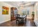 Dining room features modern light fixture and access to the kitchen and living areas at 2468 Coco Palm Cir, Wesley Chapel, FL 33543