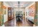 Dining room with elegant chandelier, large windows, and decorative columns at 2468 Coco Palm Cir, Wesley Chapel, FL 33543