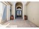 Covered front entrance with decorative double doors, side-lite, transom window, and brick-paved ground at 2468 Coco Palm Cir, Wesley Chapel, FL 33543