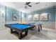 Bright game room featuring a pool table, ping pong table, and modern ceiling fan at 2468 Coco Palm Cir, Wesley Chapel, FL 33543
