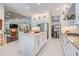 Kitchen with white cabinets, stainless appliances, center island, and open layout at 2468 Coco Palm Cir, Wesley Chapel, FL 33543