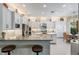 Modern kitchen boasts white cabinets, stainless steel appliances, and a center island at 2468 Coco Palm Cir, Wesley Chapel, FL 33543